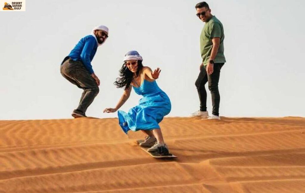 Sandboarding on red dunes during evening desert safari Dubai