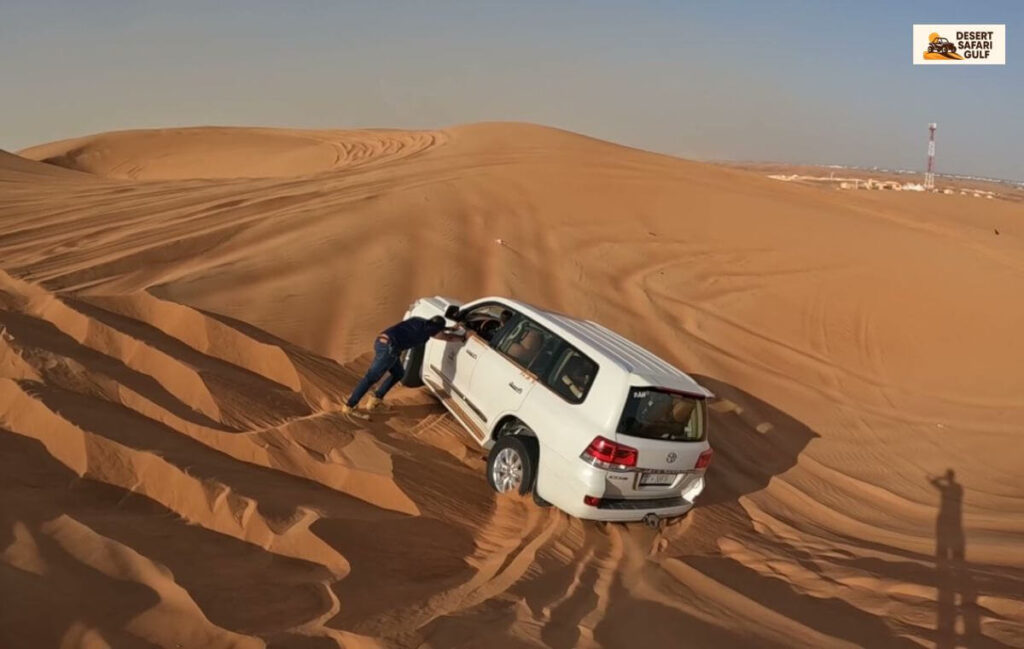 Dubai desert safari Land Cruiser dune bashing during sunset