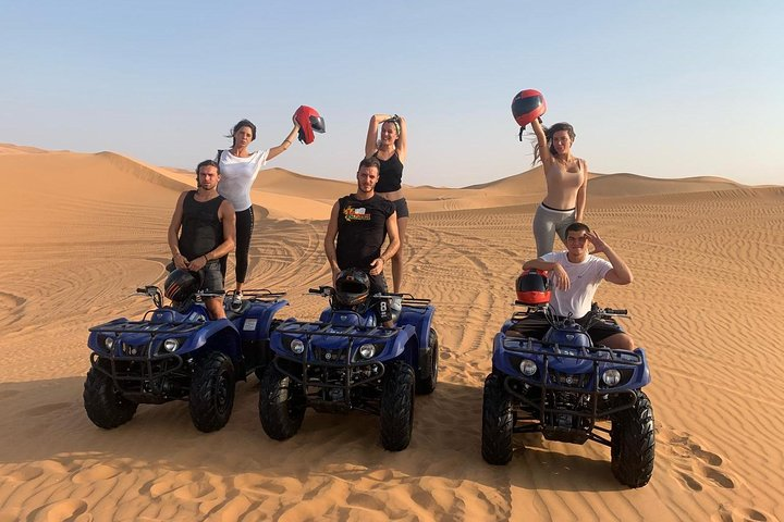 Tourists enjoying quad biking in Lahbab Red Dunes β Red Dunes Desert Safari Dubai adventure experience
